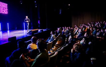 Speaker addressing the crowd at the Bright Ideas Gathering.