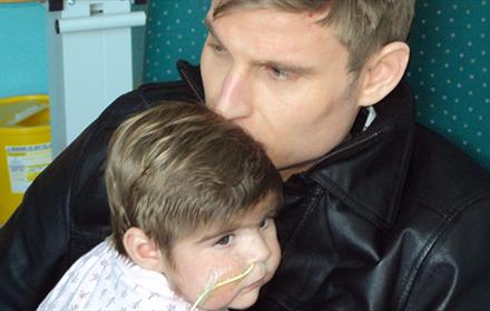 Scott Bennett kissing his daughter on the head