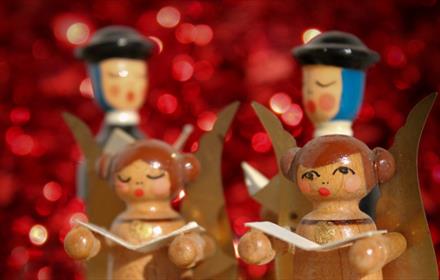 Wooden figure display showing four carol singers