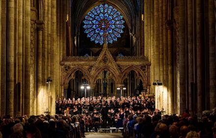 Durham University Orchestral Society performing beneath the Rose Window in the Nave of Durham Cathedral