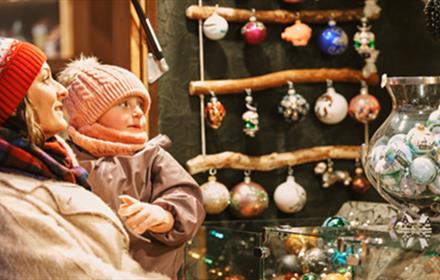 Mother and baby looking at baubles at the Christmas Market, Lumley Castle.