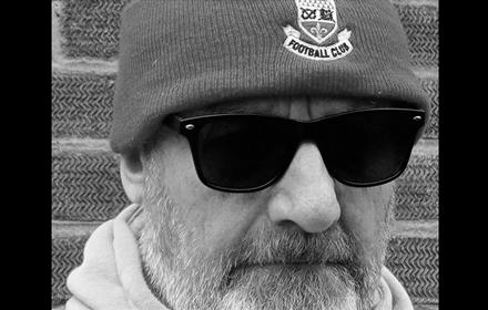 Close up shot of Andy Gilbert's face in black and white. 
