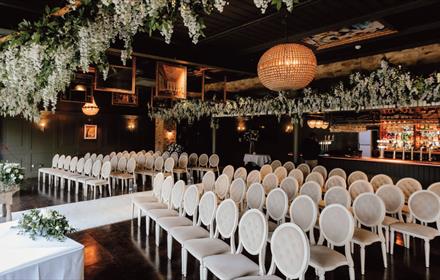 Bowburn Hall staged beautifully for a wedding with rows of chairs and floral decorations.