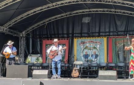 Musicians performing folk music on stage