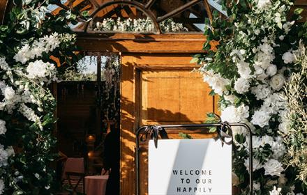 Floral wedding decorations around a door at Ramside Hall Hotel.