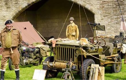 1940s army vehicles and people wearing historical military uniform