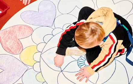 Child colouring in mandala pattern.