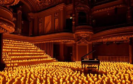 A grand piano in a room with thousands of candles.