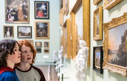 Two children look at artwork at The Bowes Museum