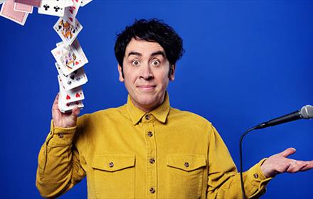 Pete Firman throwing a pack of cards ito the air
