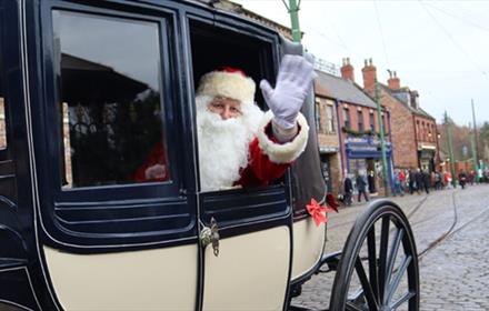 Father Christmas waving from a carriage at Beamish Museum.