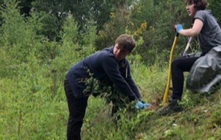 Two teenagers planting trees at Low Barns Nature Reserve