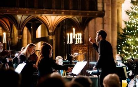 Royal Northern Sinfonia performing in front of a Christmas Tree.