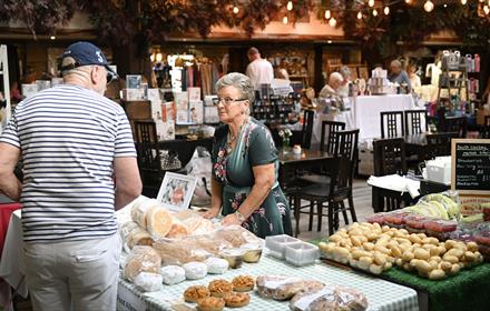 People buying food and drink from the Tuesday market at South Causey Inn