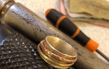 Silver spinner ring and tools.