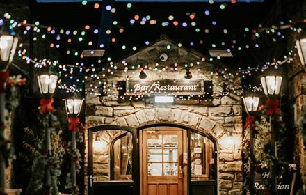 Fairy lights and warm lighting leading to South Causey Inn's Bar and Restaurant area.