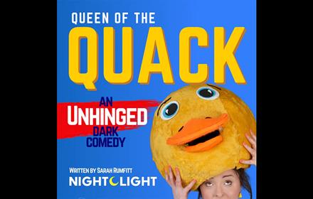 Queen of the Quack. Woman with a duck hat on her head.