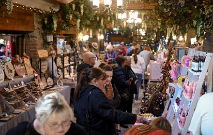 Visitors enjoying browsing stalls at South Causey Inn's Christmas market.