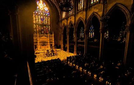 Musicians surrounded by candles in the chapel.