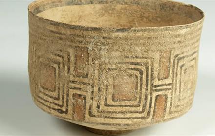 A small ceramic bowl decorated with geometric patterns.