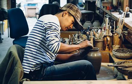 A potter making a vase.