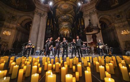 U2 tribute band surrounded by candles.