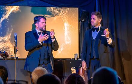 Tim Lichfield and Andy Larmouth, Magic Duo on stage holding eggs.