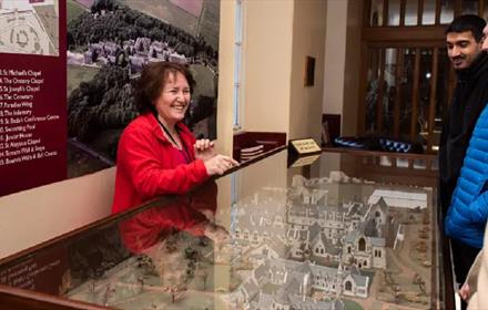 Visitors being shown a model of Ushaw by staff.