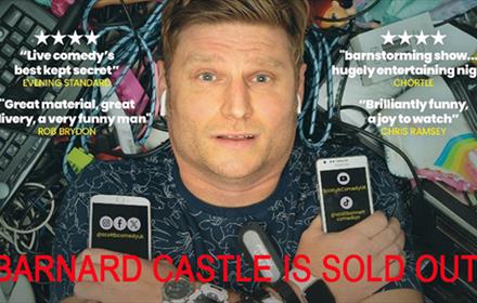 Scott Bennett surrounded by phones, watches, wires and keyboards
