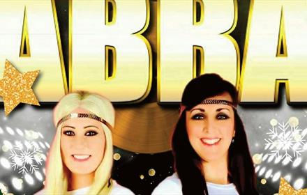 Abba Tribute 'Voulez 2' members smiling. Poster decorated with snowflakes and gold stars.