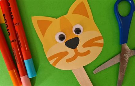 Pens, scissors and a handcrafted cat puppet