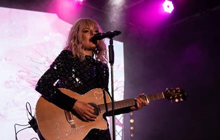 Taylor Swift Tribute Act - Katie Cowie - performing on stage with her guitar