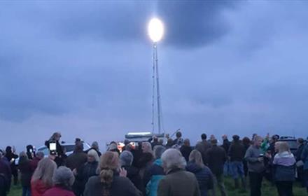 Crowds commemorating VE Day with a beacon.