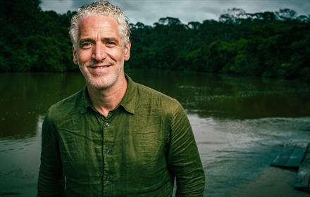 Gordon Buchanan standing in front of a lake.
