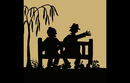 Illustration of the silhouettes of two people sitting on a  bench