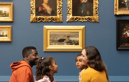 A family looking at artwork at The Bowes Museum 
