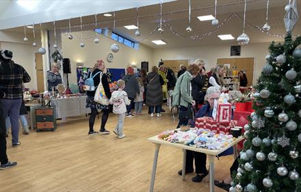 People browsing stalls at Sacriston Christmas Market at The Fulforth Centre