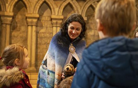 Elizabeth Baker, local storyteller and writer, entertaining children at Durham Cathedral with thought-provoking tales.