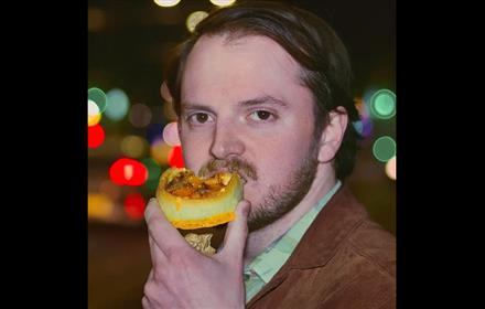 Headshot of Cobin Millage eating a snack