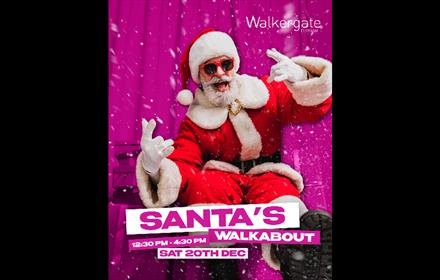 Santa Claus wearing red festive suit and sunglasses.