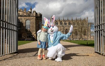 A little girl posing for a photo with the Easter Bunny at Auckland Palace