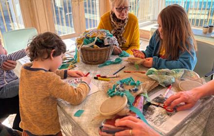 Children and families enjoying arts and crafts activities at Auckland Tower with artists.
