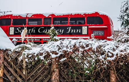 Double decker bus at South Causey Inn on a snowy day.