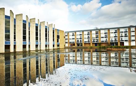 View of the exterior of Van Mildert College with lake to foreground.