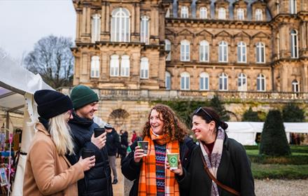 Four friends enjoying festive drinks at The Bowes Museum Winter Market. ©TheBowesMuseum