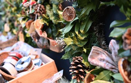 Christmas decorations at Raby. Wreathes made of pine cones, bows and oranges.