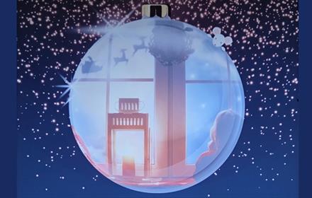 A festive scene inside a Christmas bauble.