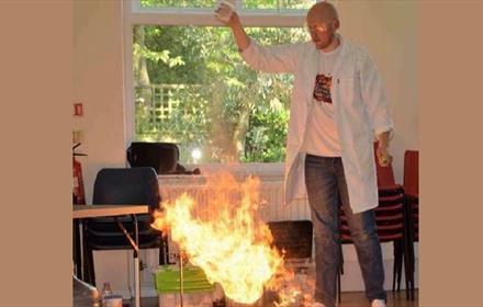 A man performing a science experiment with fire.