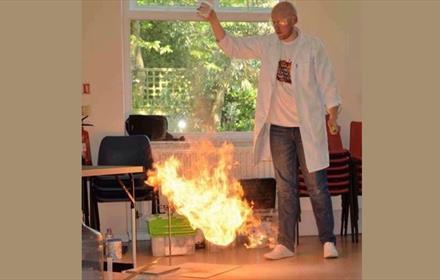 Man demonstrating a science experiment with fire