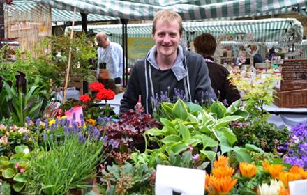 Man with flowers at Durham City Farmers' Market